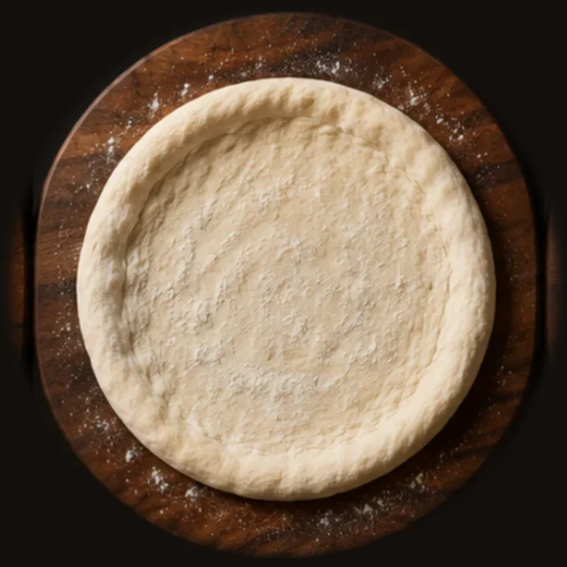 The dough stretched by hand into a round base