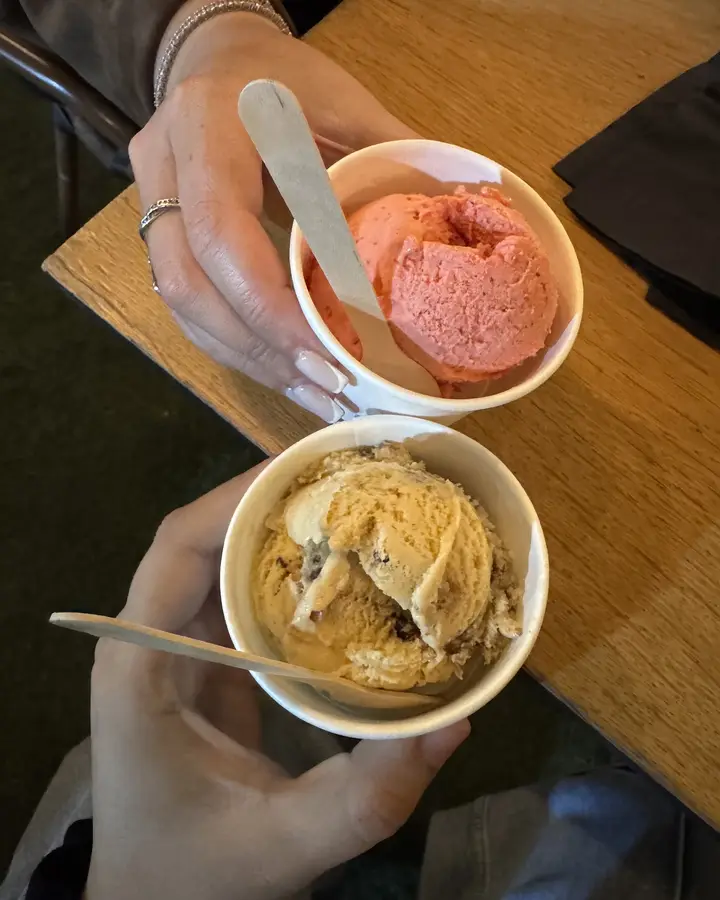 Two guests holding cups of gelato