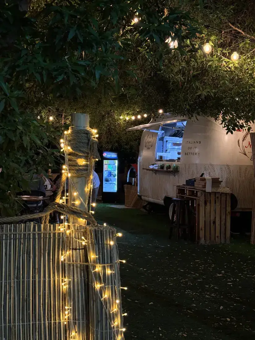 The path to the truck lined with fairy lights